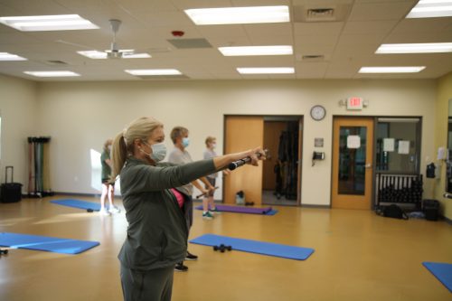 A group of older people taking a fitness class.