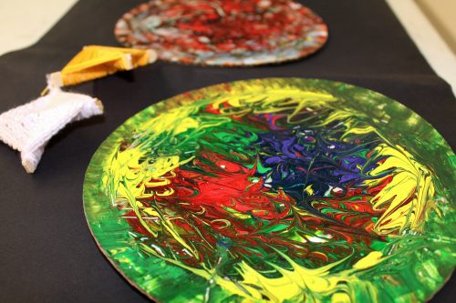 A plate covered in paint for crafts.
