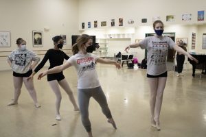 Young ballet dancers rehearsing in a studio.