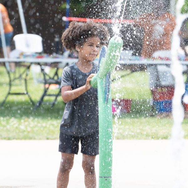Child playing on Douglass Park splash pad.
