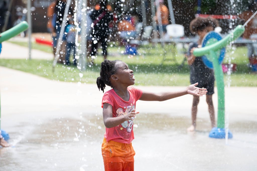 Child playing in Douglass Park splash pad.