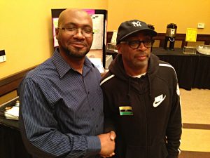 Jameel Jones standing with Spike Lee at the Virginia Theatre in Champaign, Illinois.