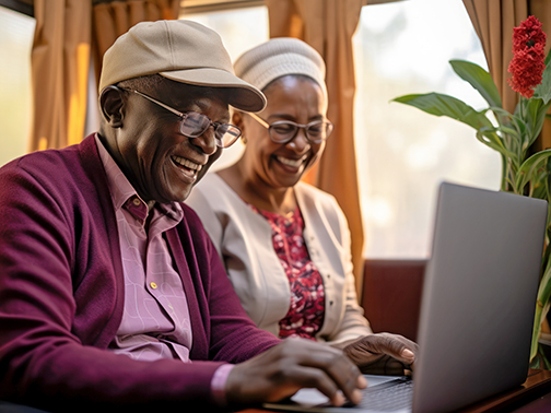 Senior African American couple using laptop. Generative AI.