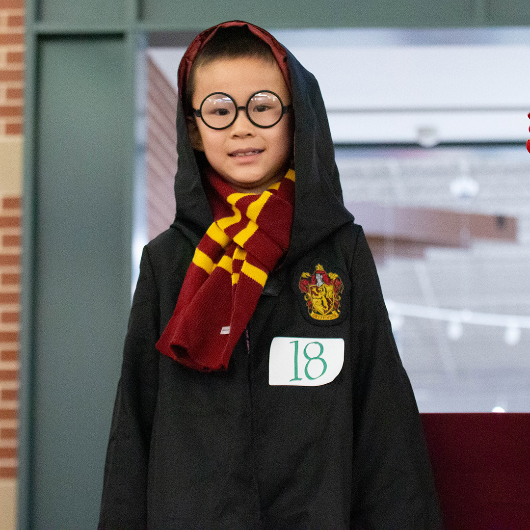 Child dressed in Harry Potter costume.