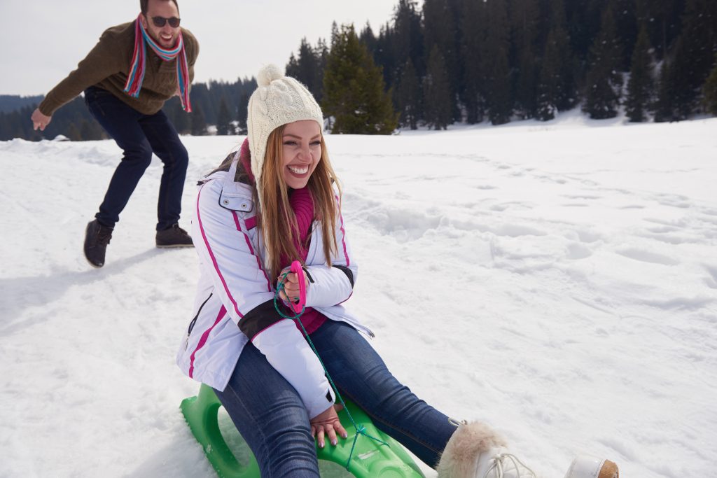 romantic winter  scene, happy young couple having fun on fresh show on winter vacation, mountain nature landscape