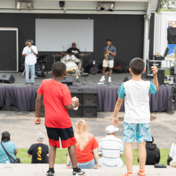Two children watch live music