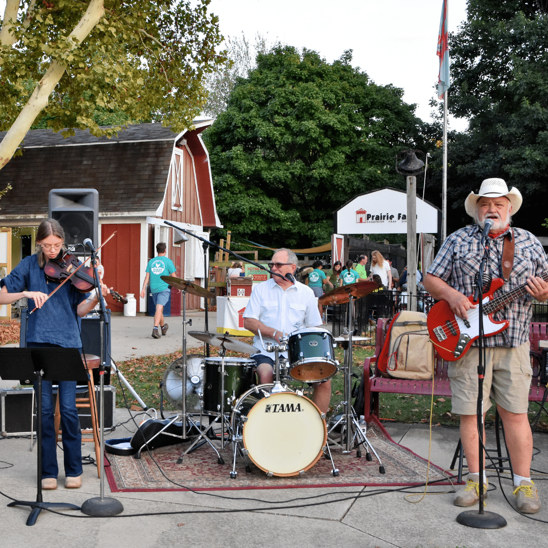 A country music band plays outdoors at a farm.