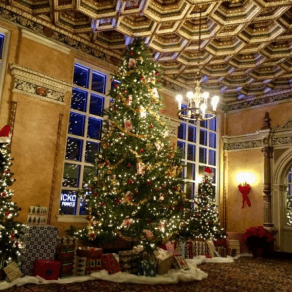 Two decorated holiday trees are surrounded by wrapped gifts at the historic Virginia Theatre
