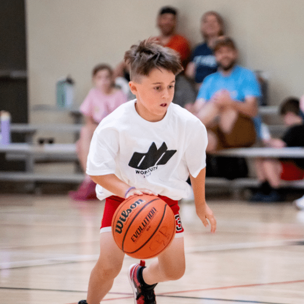 A young boy dribbles a basketball