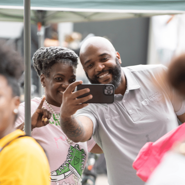 Two adults pose for a selfie at the 2025 Juneteenth Celebration in Champaign's Douglass Park.