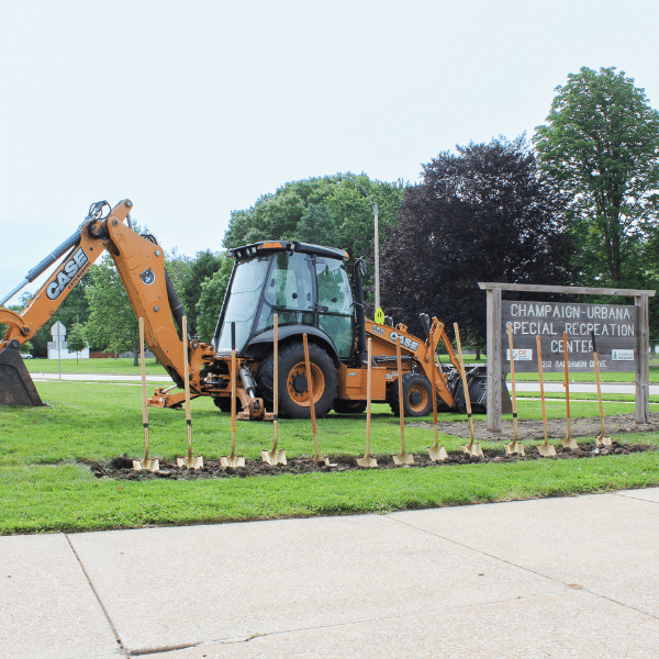An excavator sits behind the CUSR Center wooden sign.