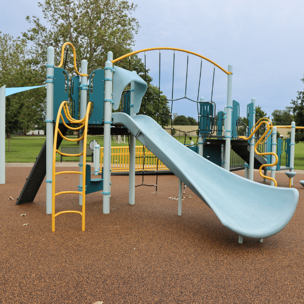 New Garden Hills Park playground, featuring a slide, a climbing wall, and other features in a turquoise and yellow color scheme.
